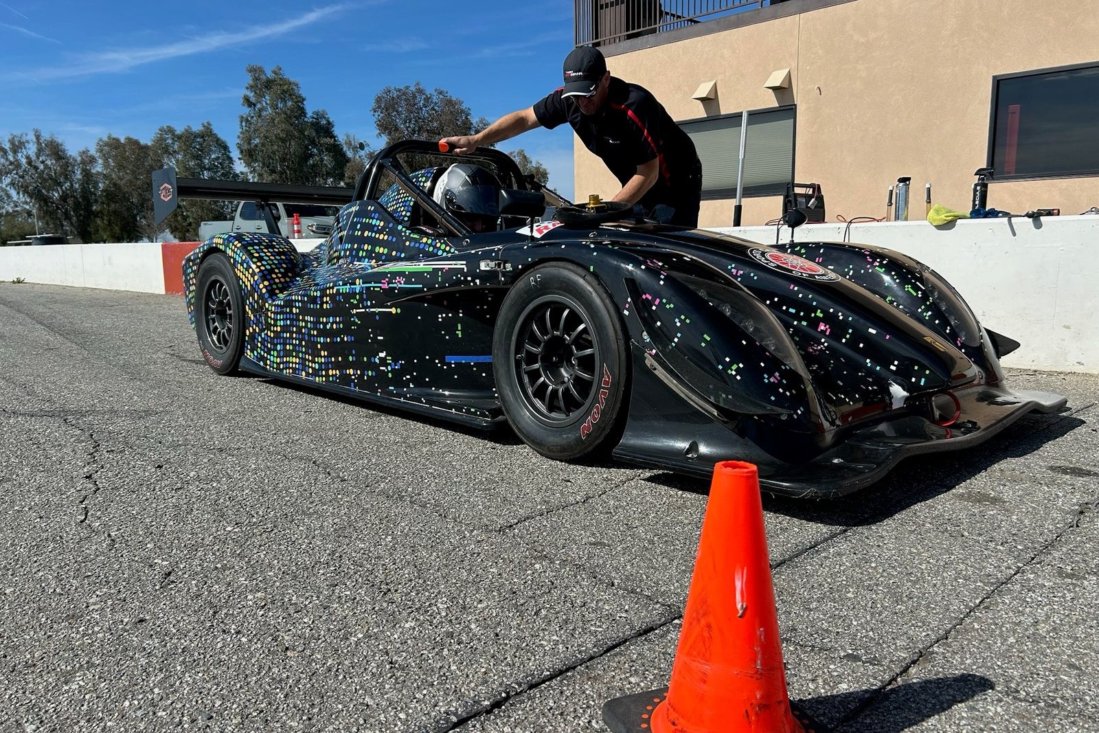 A FastLane Radical SR1 sports racer staged in the paddock at Buttonwillow Raceway.